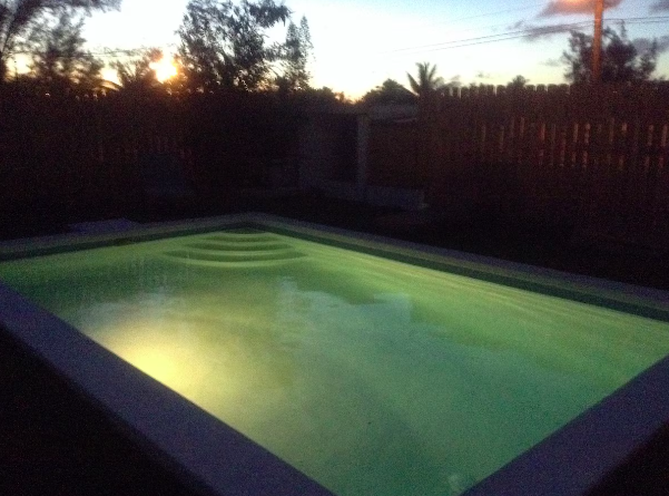 Sunset view of private pool at Nassau vacation rental